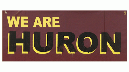 Text We are Huron on maroon background